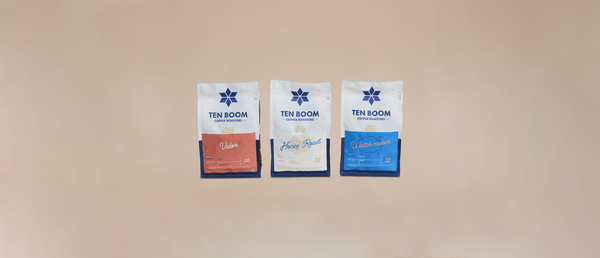 Three 'TEN ROOM' branded packages on a beige background